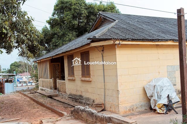 Maison crème aux fenêtres à persiennes à Pélengana